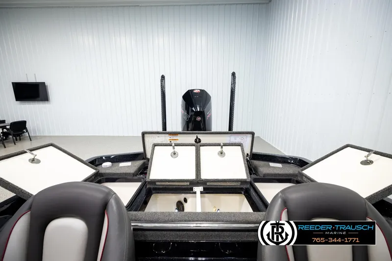 Slide: The Image of 2023 Ranger Z519 boat interior with open storage compartments in a showroom. - 18