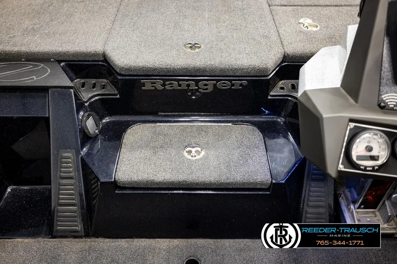 Slide: The Image of 2023 Ranger Z519 boat interior with carpeted deck and control panel. - 21