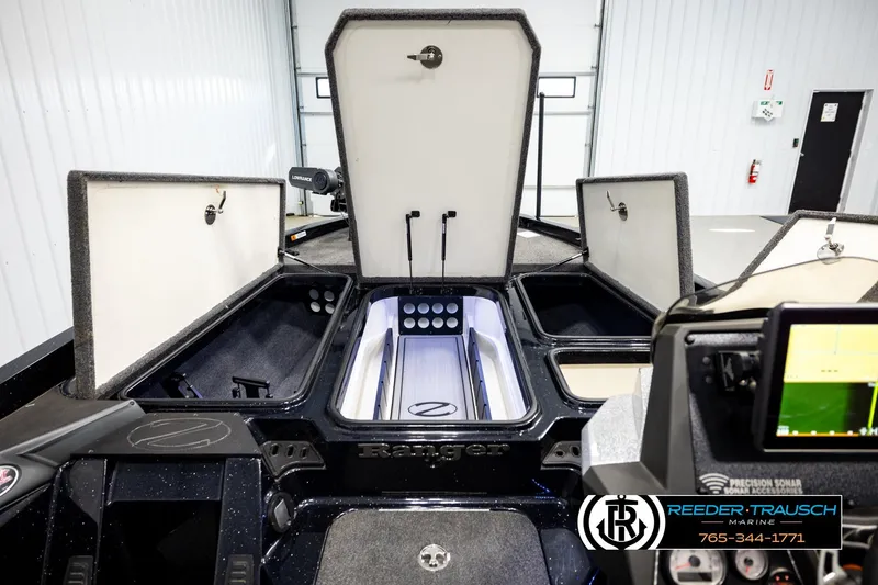 Slide: The Image of 2023 Ranger Z519 boat interior with open storage compartments and navigation equipment. - 24