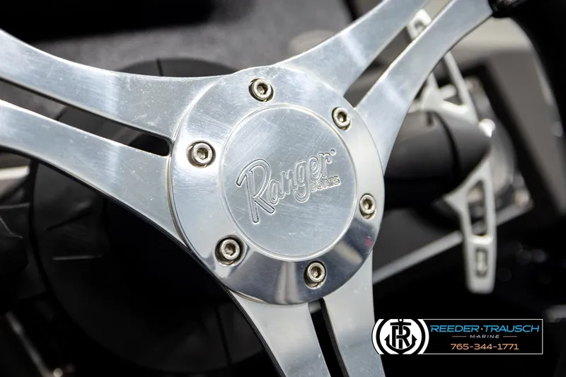 Slide: The Image of Close-up of 2023 Ranger Z519 steering wheel with logo and Reeder-Trausch Marine branding. - 27
