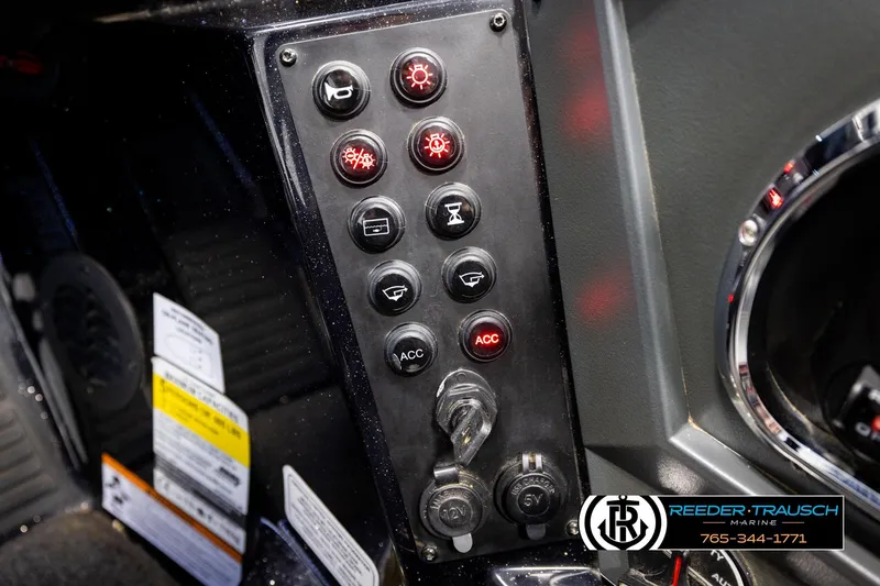 Slide: The Image of Dashboard controls of a 2023 Ranger Z519 boat with various switches and ignition key. - 34