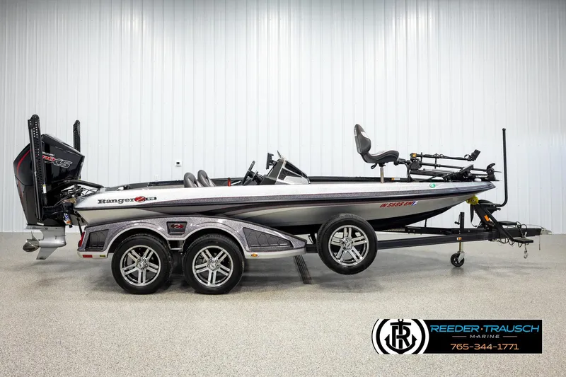 Slide: The Image of 2023 Ranger Z519 boat in showroom, side view with trailer and motor. - 4
