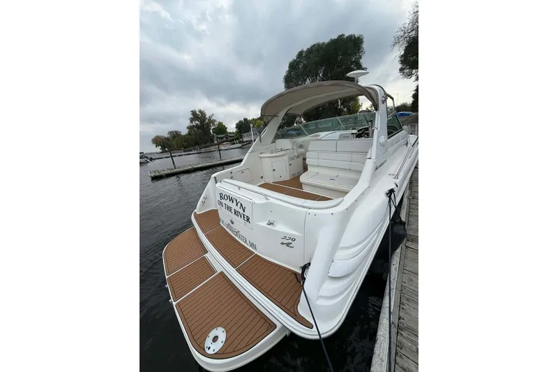 The Image of 1997 Sea Ray Sundancer 330 docked, featuring spacious deck and seating area. - 1