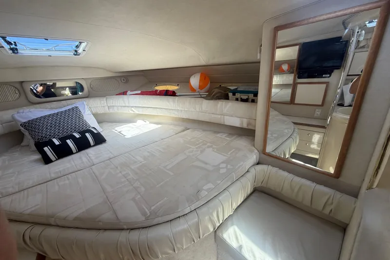 Slide: The Image of Interior cabin of a 1997 Sea Ray Sundancer 330 with bed, pillows, and mirror. - 11