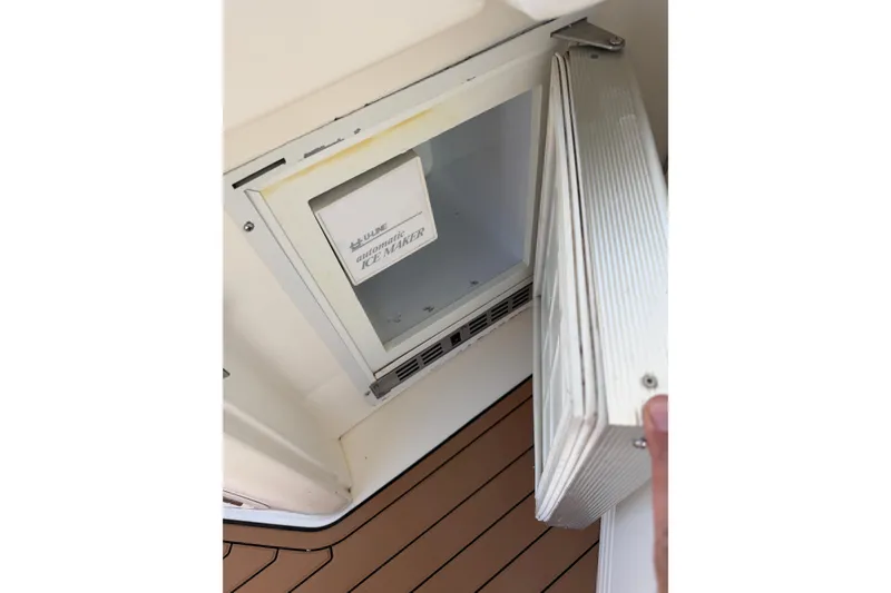 Slide: The Image of Open ice maker on 1997 Sea Ray Sundancer 330 boat, showing interior compartment. - 14