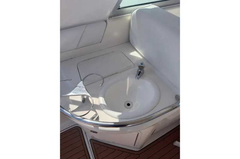 Slide: The Image of 1997 Sea Ray Sundancer 330 boat sink with chrome faucet and white countertop. - 15