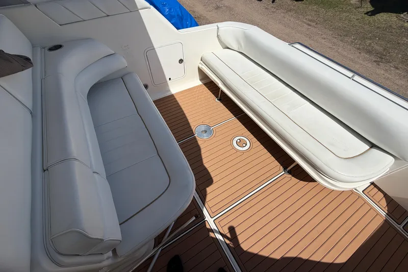 Slide: The Image of 1997 Sea Ray Sundancer 330 boat interior with white seating and teak flooring. - 18
