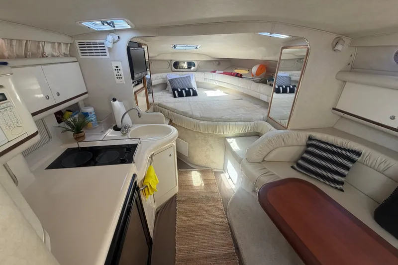 Slide: The Image of Interior of a 1997 Sea Ray Sundancer 330 yacht, featuring a cozy cabin and kitchenette. - 5