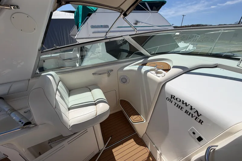 Slide: The Image of 1997 Sea Ray Sundancer 330 cockpit with white seating and wooden flooring. - 8