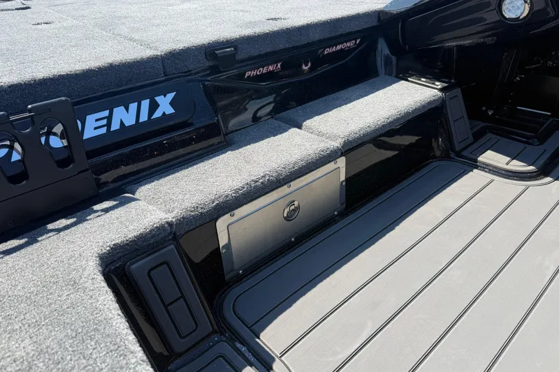 Slide: The Image of 2026 Phoenix 921 Elite X boat interior with carpeted deck and storage compartments. - 10