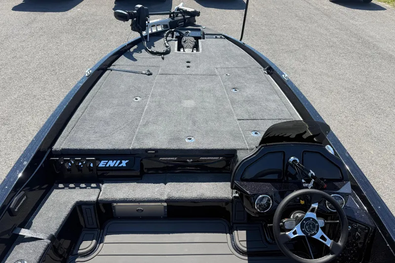 Slide: The Image of 2026 Phoenix 921 Elite X boat interior with steering wheel and spacious deck. - 14