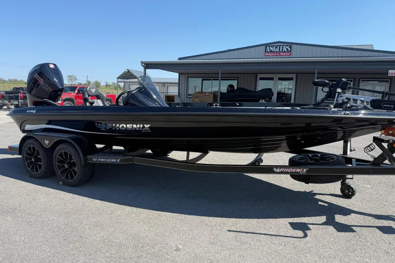Slide: The Image of 2026 Phoenix 921 Elite X boat on trailer outside Anglers Outpost & Marine. - 3