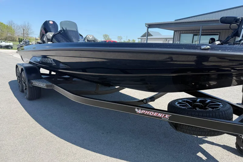 Slide: The Image of 2026 Phoenix 921 Elite X boat on trailer, parked outdoors. - 5