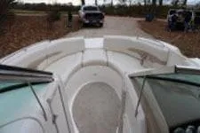 Slide: The Image of 2002 Chaparral Sunesta 263 boat interior with white seating and open deck view. - 11