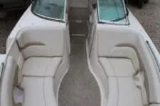 Slide: The Image of 2002 Chaparral Sunesta 263 boat interior with white seating and dual windshields. - 12