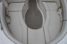Slide: The Image of 2002 Chaparral Sunesta 263 boat interior seating area, featuring cushioned seats. - 13