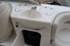 Slide: The Image of 2002 Chaparral Sunesta 263 boat interior with sink and storage compartments. - 7