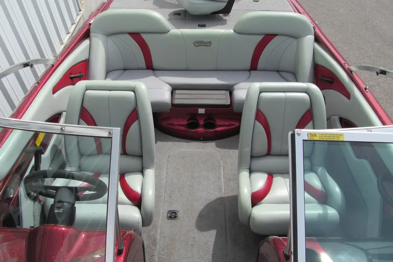 Slide: The Image of Interior of a 2000 Triton SF-21 boat with red and gray seating. - 13