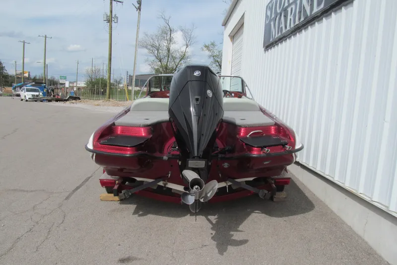 Slide: The Image of Rear view of a 2000 Triton SF-21 boat with an outboard motor. - 4