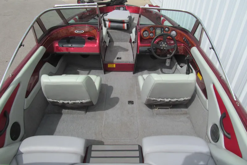Slide: The Image of Interior of a 2000 Triton SF-21 boat with red accents and gray seating. - 5