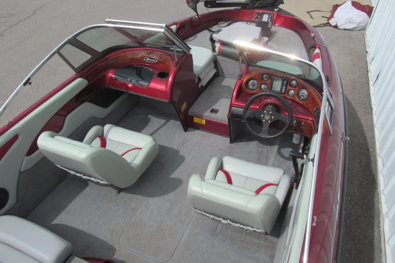 Slide: The Image of Interior of a 2000 Triton SF-21 boat with red and white seating. - 6