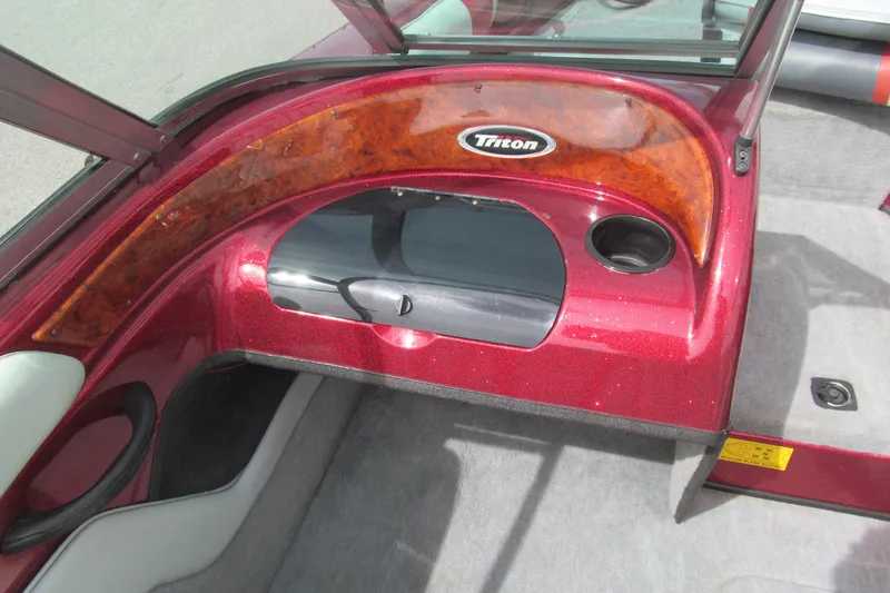 Slide: The Image of Interior of a 2000 Triton SF-21 boat with red and wood accents. - 8