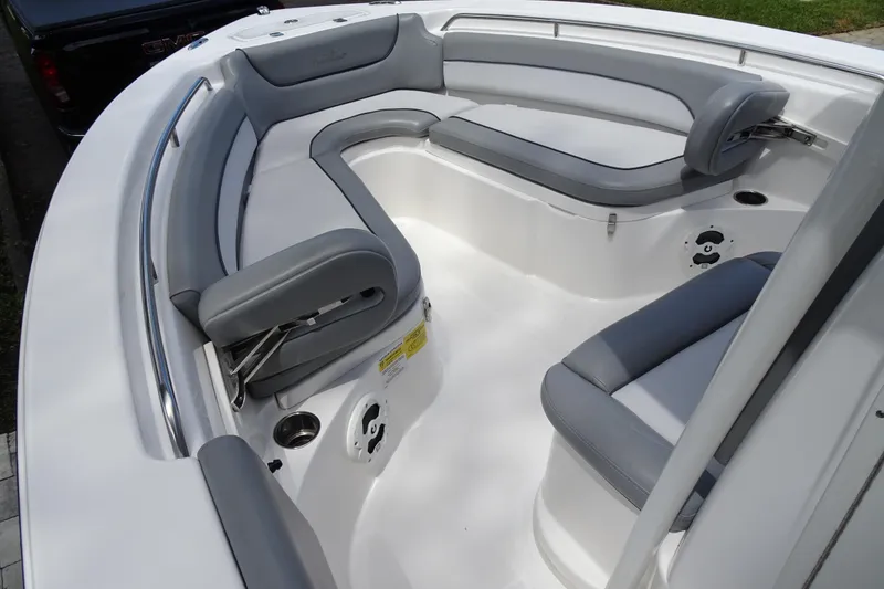 Slide: The Image of 2022 NauticStar 2302 Legacy boat interior with gray cushioned seating and stainless steel railings. - 10