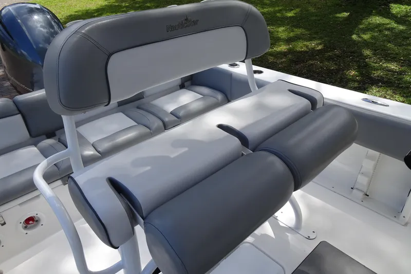 Slide: The Image of 2022 NauticStar 2302 Legacy boat seating with gray upholstery and white frame. - 20