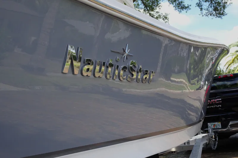 Slide: The Image of 2022 NauticStar 2302 Legacy boat on trailer, side view with logo. - 5