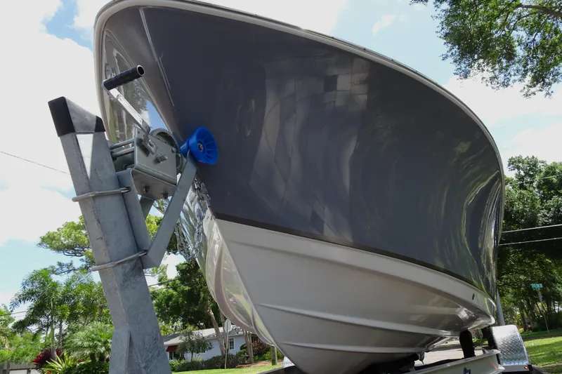 Slide: The Image of 2022 NauticStar 2302 Legacy boat on trailer, viewed from the front. - 6