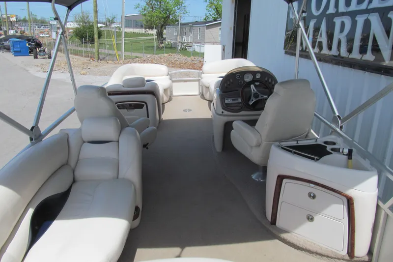 Slide: The Image of 2008 Sun Tracker Party Barge 25 Regency Edition interior with plush seating and helm. - 5