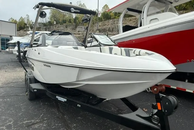 Slide: The Image of 2021 Malibu Wakesetter 21 VLX boat on trailer, sleek white design, ready for water sports. - 14