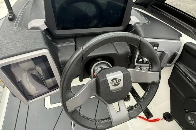 Slide: The Image of 2021 Malibu Wakesetter 21 VLX steering wheel and dashboard, featuring modern controls and display. - 15
