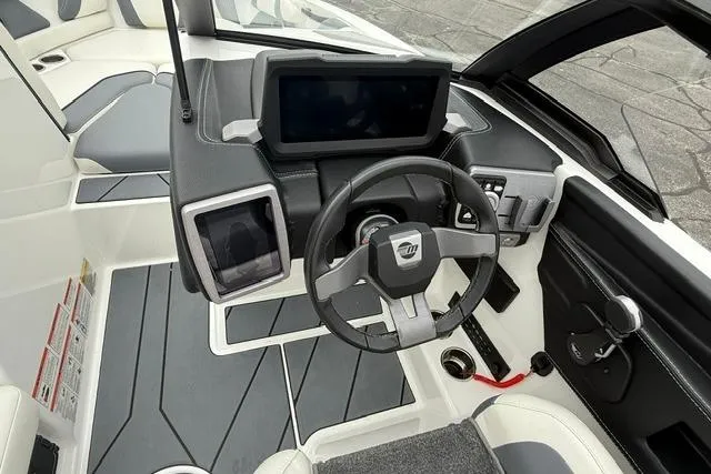 Slide: The Image of 2021 Malibu Wakesetter 21 VLX boat interior with modern dashboard and steering wheel. - 16