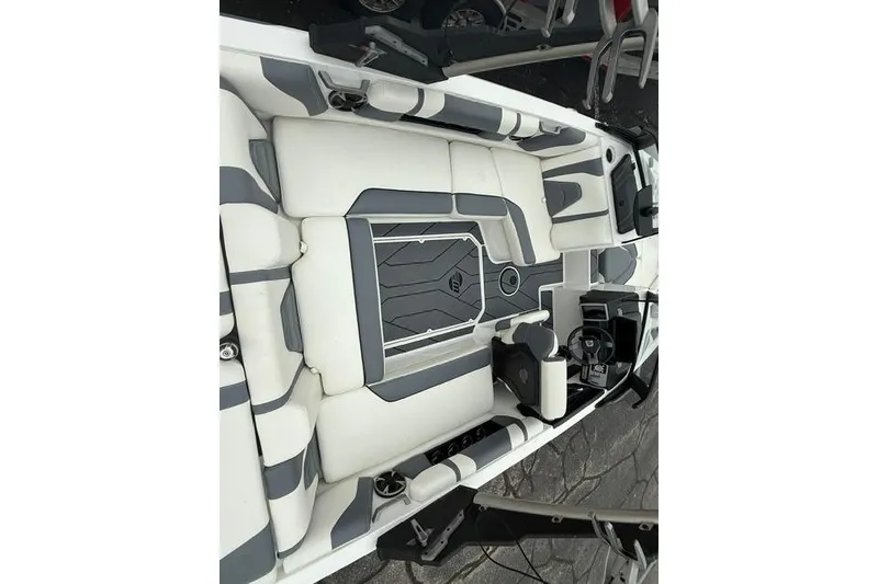 Slide: The Image of 2021 Malibu Wakesetter 21 VLX boat interior with gray and white seating. - 17