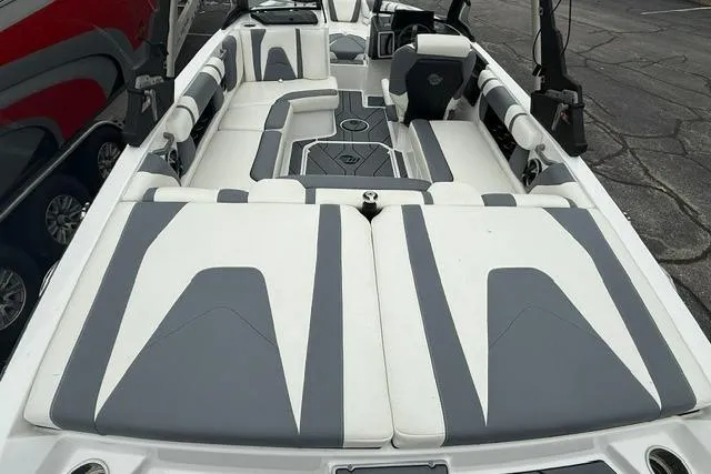 Slide: The Image of 2021 Malibu Wakesetter 21 VLX boat interior with stylish gray and white seating. - 18