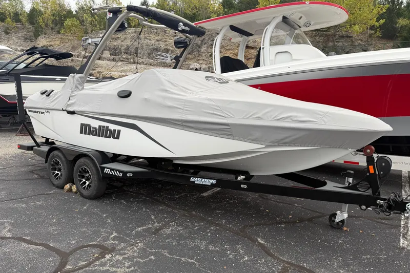 Slide: The Image of 2021 Malibu Wakesetter 21 VLX boat covered on trailer in parking lot. - 29