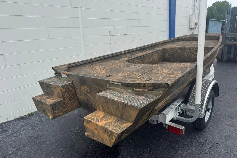 Slide: The Image of 2026 G3 Gator Tough 15 DK boat with camouflage design on a trailer. - 4