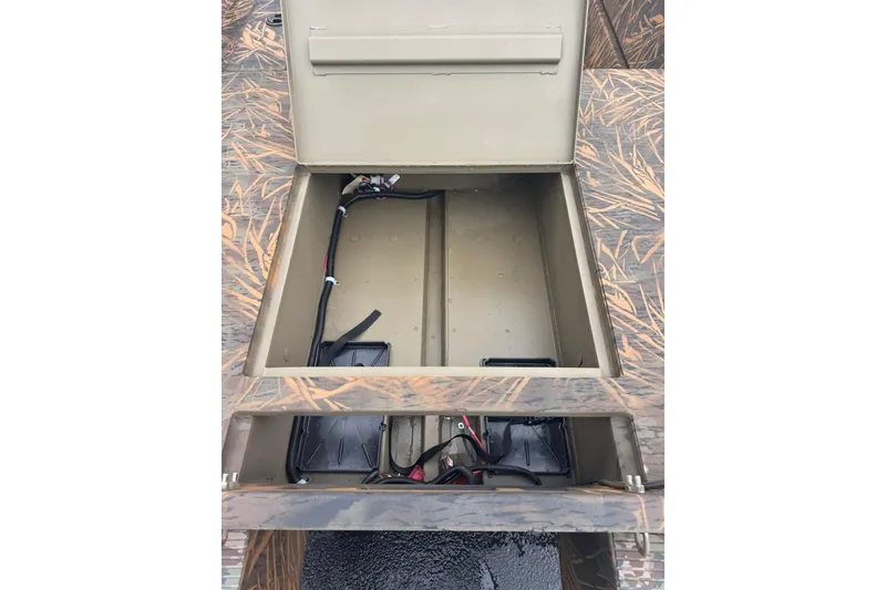 Slide: The Image of Open storage compartment of 2026 G3 Gator Tough 15 DK boat, showcasing wiring and battery setup. - 5