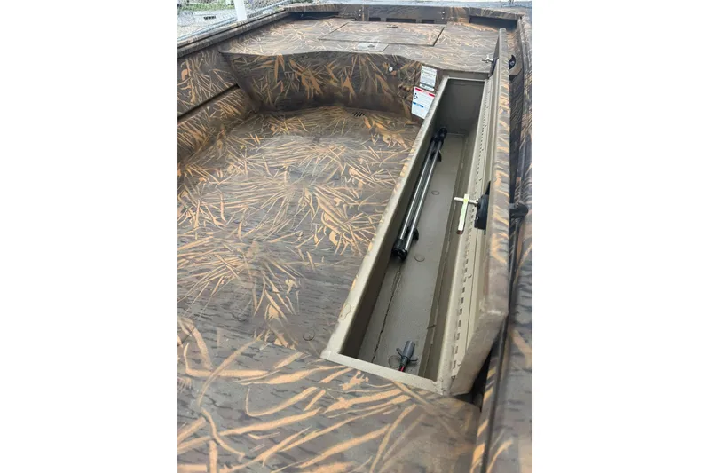 Slide: The Image of 2026 G3 Gator Tough 15 DK boat interior with camo design and storage compartment. - 6