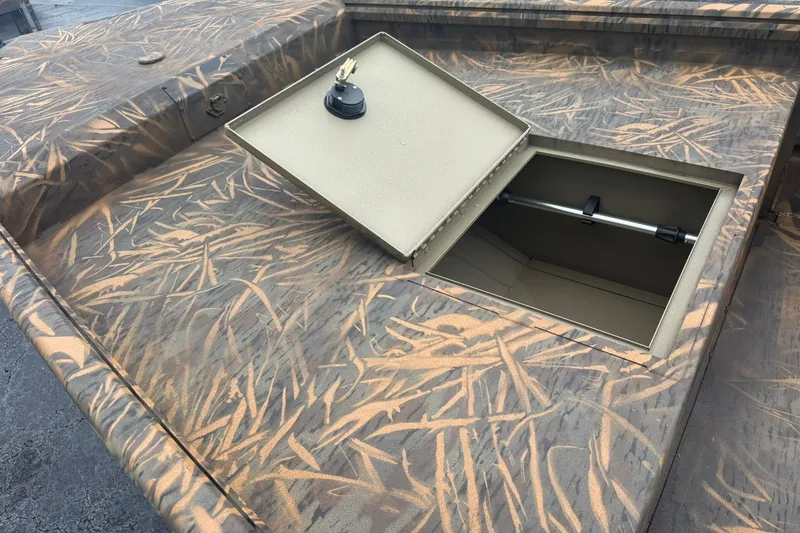 Slide: The Image of 2026 G3 Gator Tough 15 DK boat with open storage compartment, camo pattern. - 7