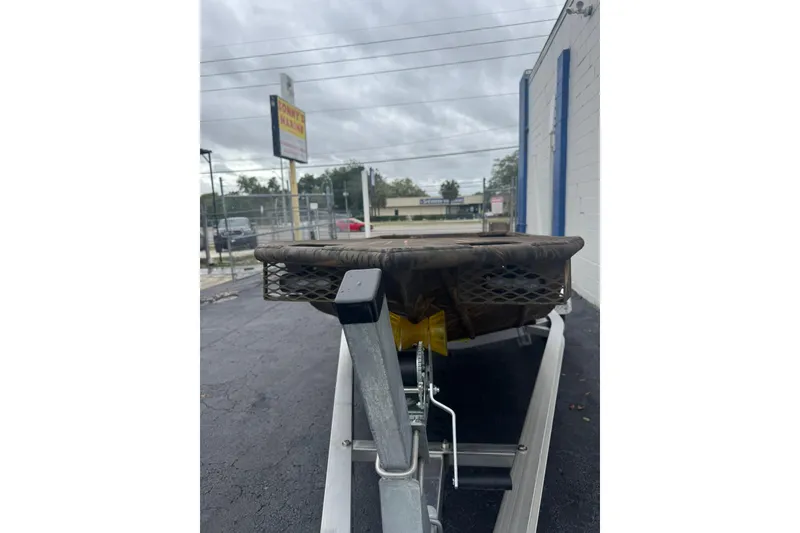 Slide: The Image of 2026 G3 Gator Tough 15 DK boat on trailer, parked outside a building. - 8