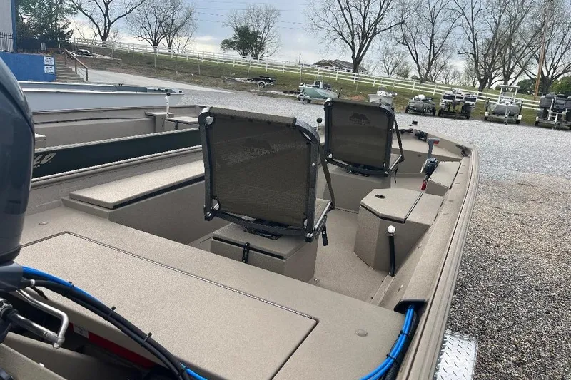 Slide: The Image of 2026 Alweld 1652VSTK boat with dual seats, parked outdoors. - 11