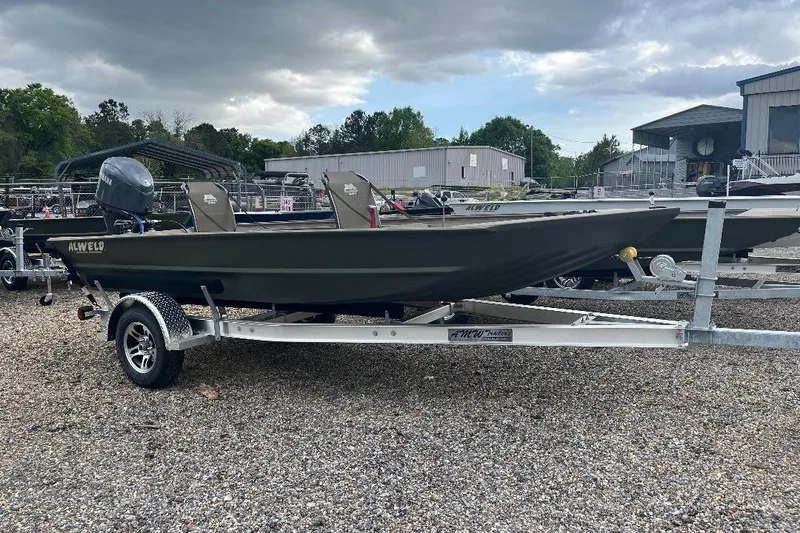 Slide: The Image of 2026 Alweld 1652VSTK boat on trailer, parked outdoors under cloudy sky. - 12