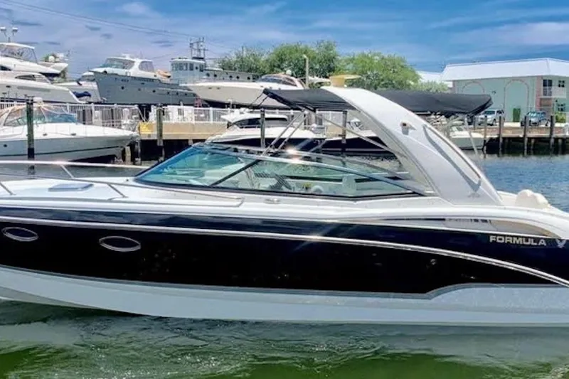 The Image of 2008 Formula 310 Sun Sport boat docked in a marina under a clear blue sky. - 0