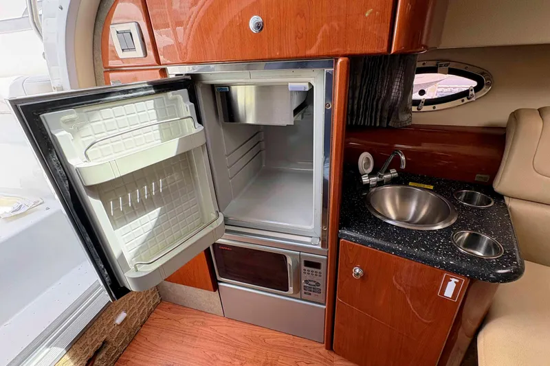 Slide: The Image of 2008 Formula 310 Sun Sport interior with open fridge, sink, and microwave. - 14