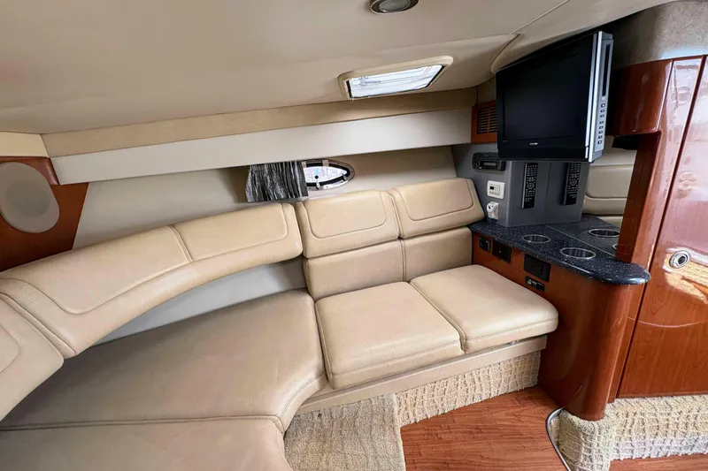 Slide: The Image of Luxurious interior of a 2008 Formula 310 Sun Sport boat with beige seating and entertainment area. - 16