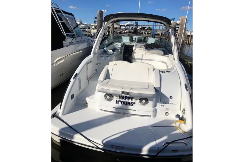 Slide: The Image of 2008 Formula 310 Sun Sport boat on display under clear blue sky. - 5