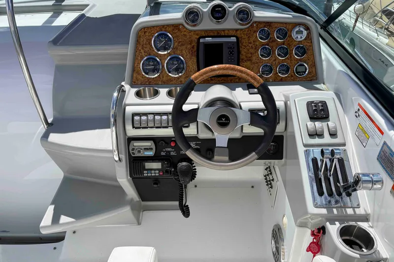 Slide: The Image of 2008 Formula 310 Sun Sport boat dashboard with steering wheel and control panel. - 9