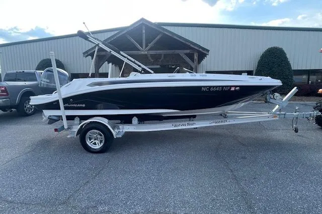 The Image of 2023 Hurricane SunDeck Sport 185 OB boat on trailer, parked outdoors. - 0